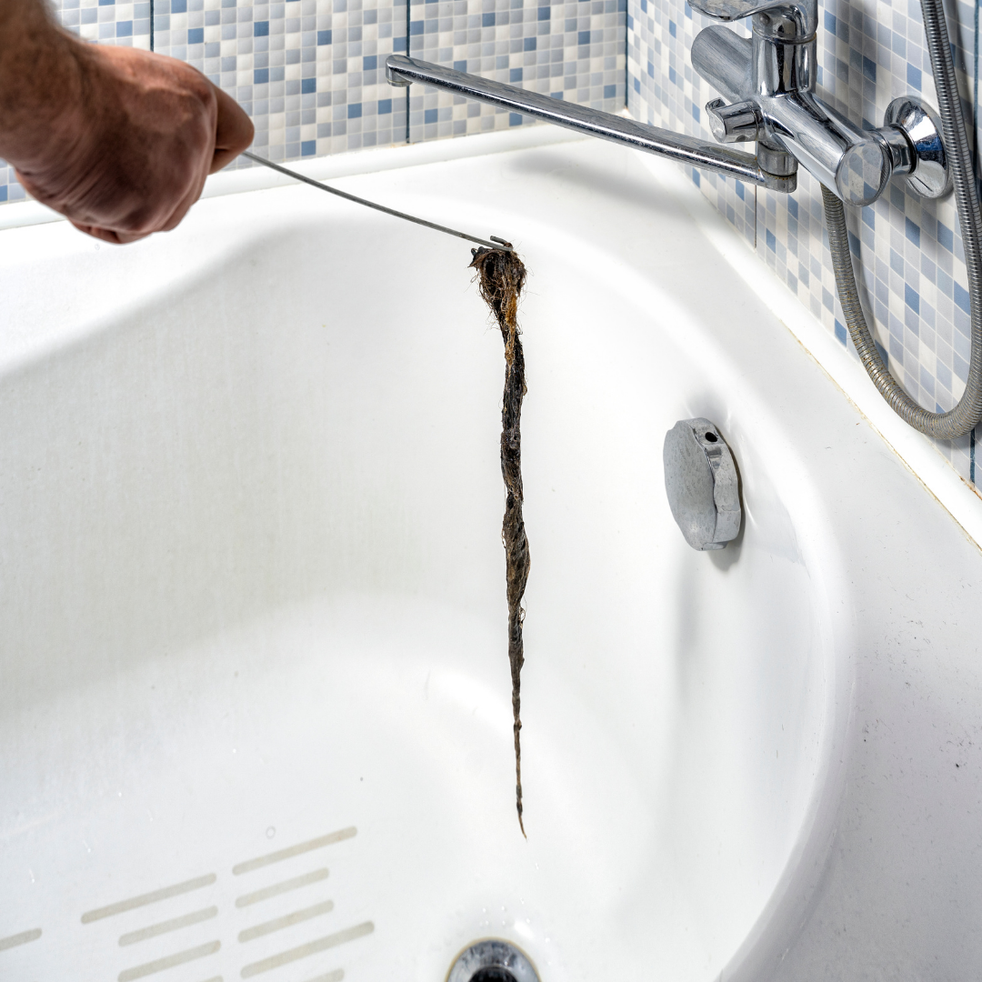 Use a plunger to dislodge wad of hair plugging bathtub drain